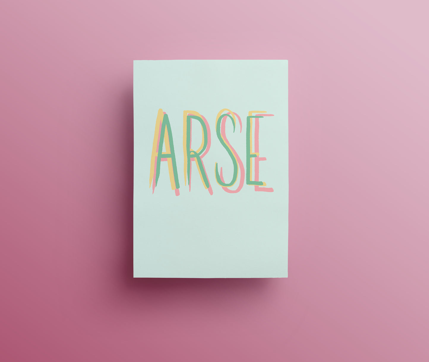 A sweary greetings card with the word 'ARSE' designed with hand drawn lettering written in green, yellow and pink capital letters on white background.