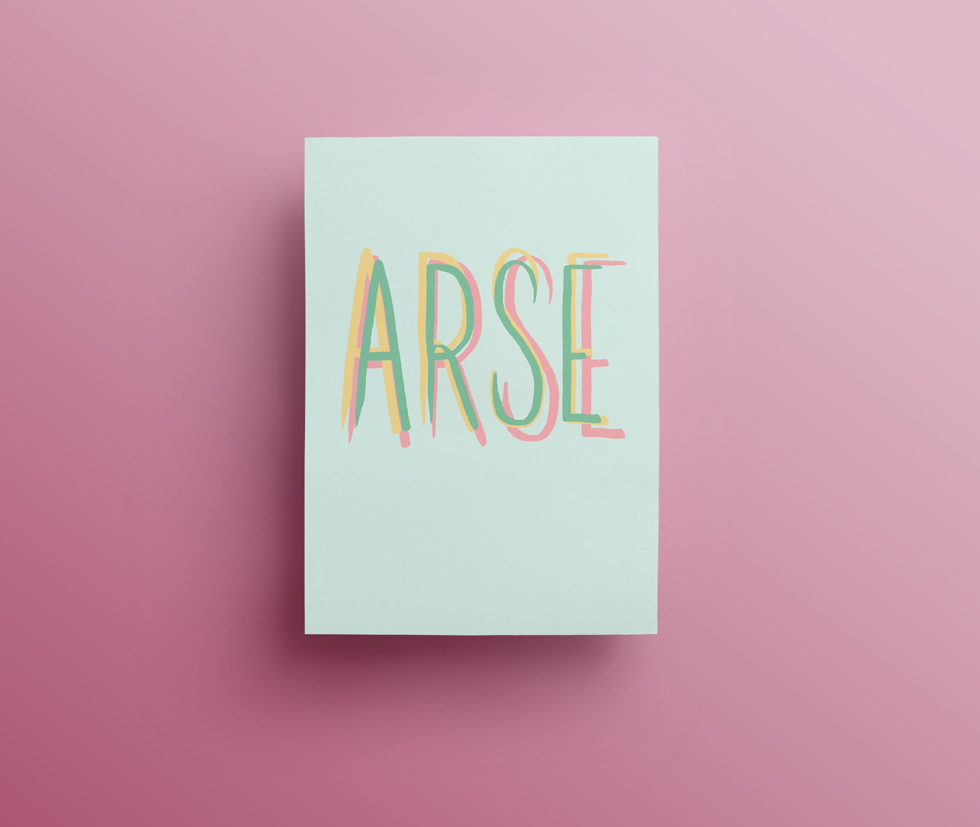 A sweary greetings card with the word 'ARSE' designed with hand drawn lettering written in green, yellow and pink capital letters on white background.