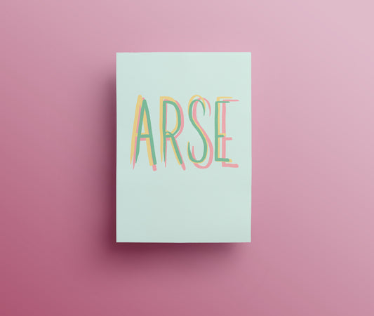 A sweary greetings card with the word 'ARSE' designed with hand drawn lettering written in green, yellow and pink capital letters on white background.