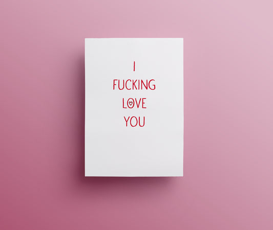 A white sweary rude greetings card with the text 'I FUCKING LOVE YOU' in red hand-drawn lettering, displayed against a pink background.