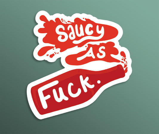 A white and red fridge magnet saying 'saucy as fuck' with a ketchup bottle squirting out the suce-like hand drawn lettering.