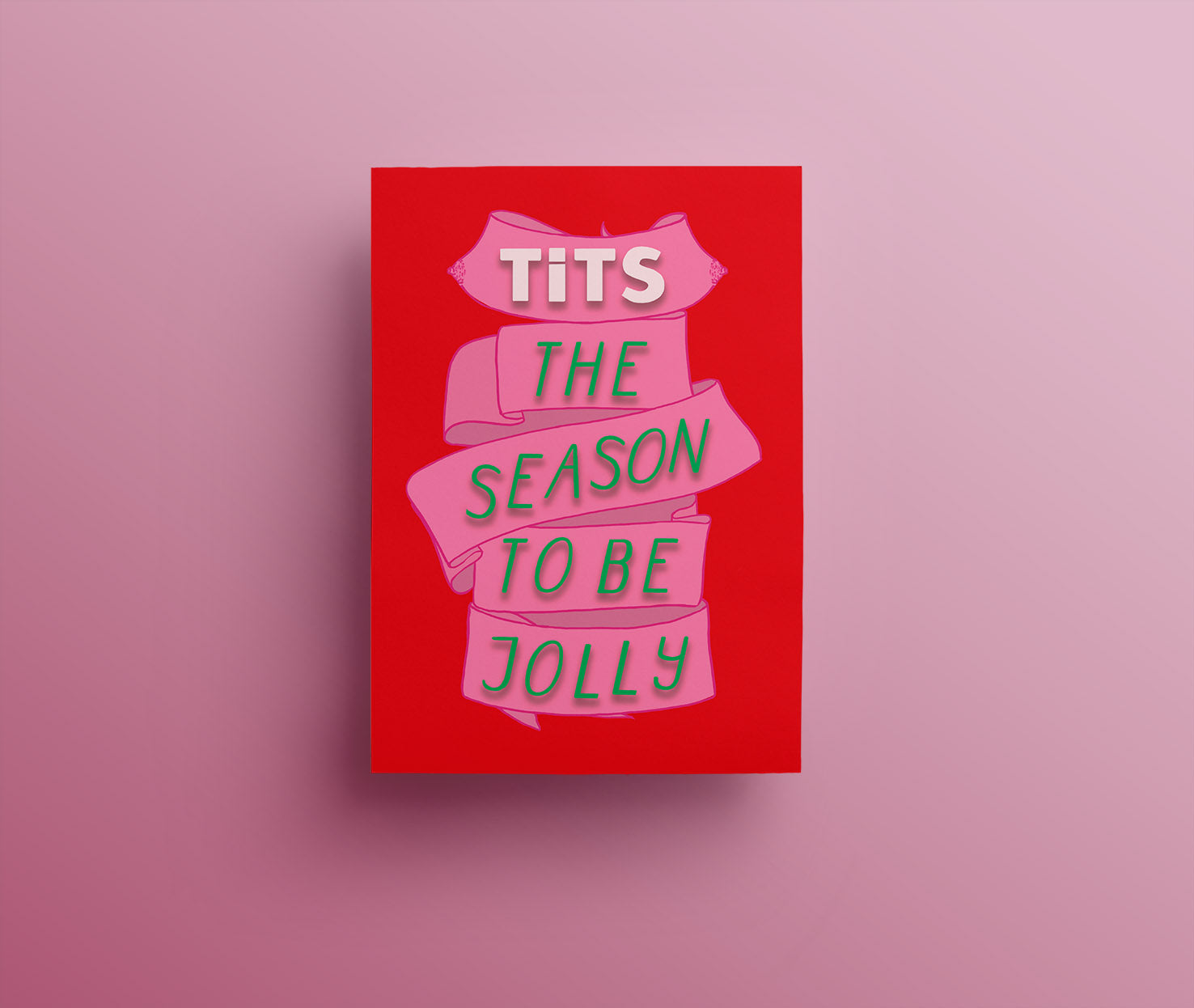 A red christmas card with a pink ribbon and beautifully festively decorated green words saying "tits the season" one section of the ribbon has a lovely pair of illustrated breasts with very pink, sparkly nipples. 