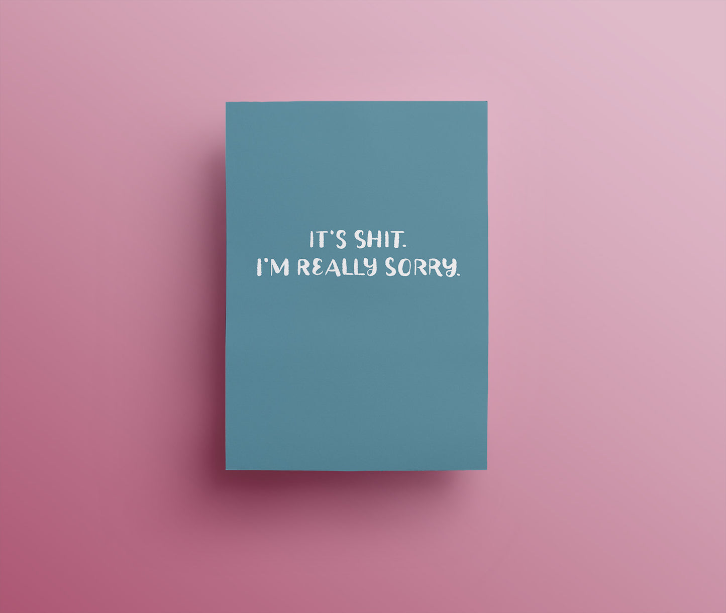 Small white hand drawn lettering saying "It's shit. I'm really sorry." on a muted blue background. 