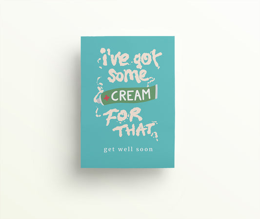 Turquoise greetings card with a tube of cream that has spurted and spelled out 'I've got some cream for that. Get well soon.' in white antiseptic cream.
