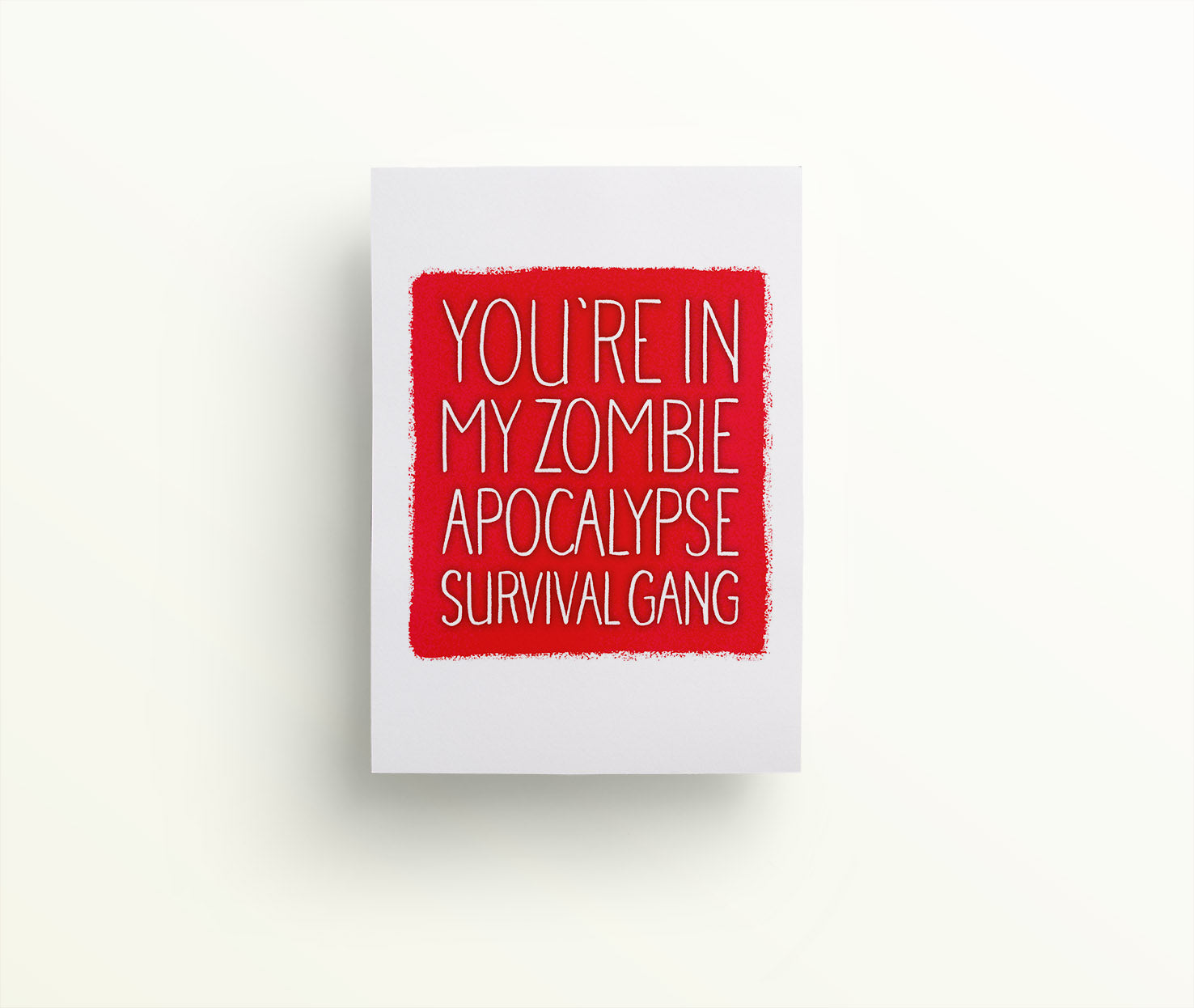 You're in my zombie apocalypse survival gang in white hand drawn lettering on a smudgy square red on a white background luxe funny greetings card